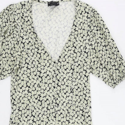 Close-up detail of ASOS women’s green floral cotton a-line, size UK 10, v-neck pullover - ruffle