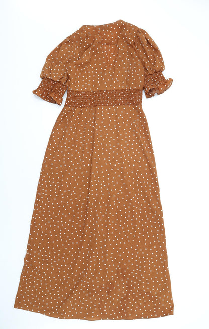 Back view of ASOS women’s brown polka dot polyester a-line, size UK 8, v-neck button