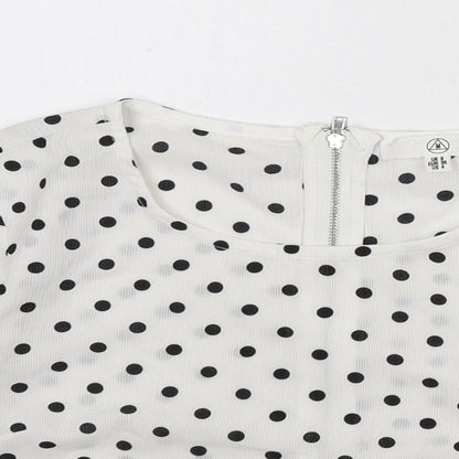 Close-up detail of Missguided women’s white polka dot polyester cropped blouse, size UK 8, round neck