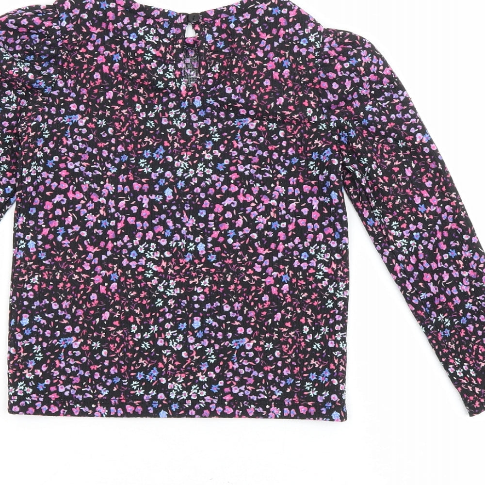 Brand and care label for Dunnes girls’ black floral polyester basic blouse, size 4-5, years round neck button