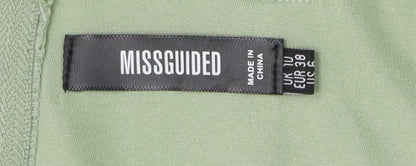 Close-up detail of Missguided Women's Green Zip Tank Top, size 10