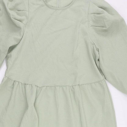 Close-up detail of Only women’s green polyester a-line, size L, round neck button - tiered