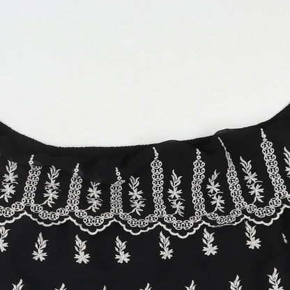 Close-up detail of Miss Selfridge women’s black geometric polyester basic blouse, off the shoulder - embroidered frill