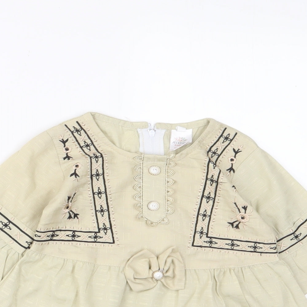 Close-up detail of Attitude girls’ beige fair isle cotton a-line, size 18, months crew neck zip - embroidered