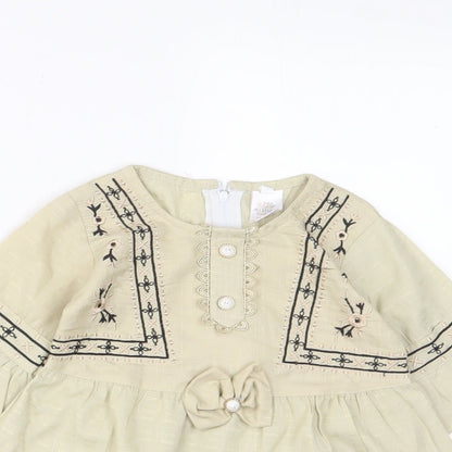 Close-up detail of Attitude girls’ beige fair isle cotton a-line, size 18, months crew neck zip - embroidered