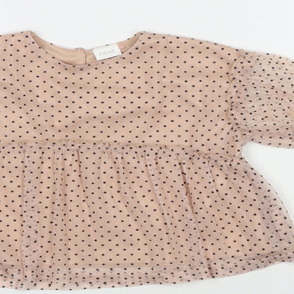 Close-up detail of Next girls’ beige polka dot polyester basic blouse, size 9-12, months round neck button
