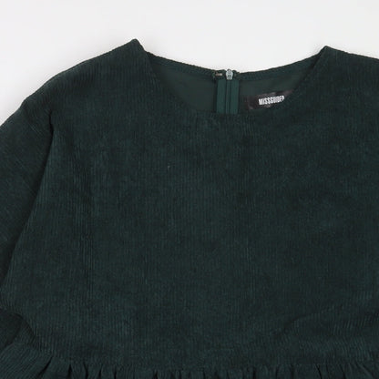 Close-up detail of Missguided women’s green polyester a-line, size UK 12, crew neck zip