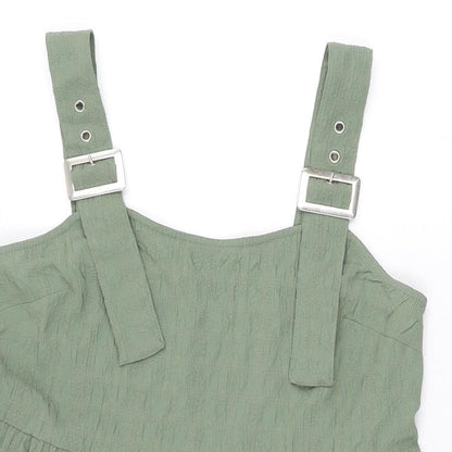 Close-up detail of ASOS women’s green polyester mini, size UK 8, square neck buckle