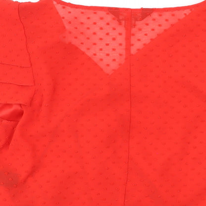 Brand and care label for Miss Selfridge women’s red polka dot polyester basic blouse, size UK 12, v-neck