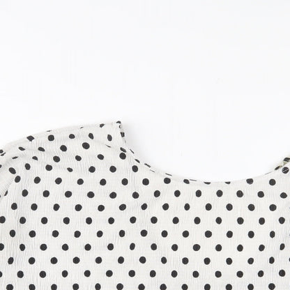 Close-up detail of Miss Selfridge women’s white polka dot polyester basic t-shirt, size UK 10, crew neck