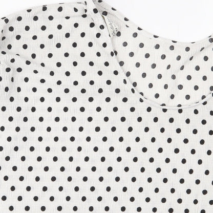 Brand and care label for Miss Selfridge women’s white polka dot polyester basic t-shirt, size UK 10, crew neck