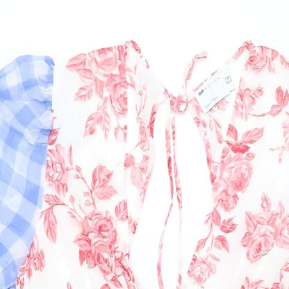 Close-up detail of ASOS women’s multicoloured floral polyester mini, size UK 16, v-neck zip