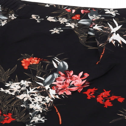 Brand and care label for Miss Selfridge women’s black floral polyester basic blouse, size UK 8, off the shoulder