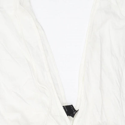 Close-up detail of ASOS women’s white viscose mini, size UK 6, v-neck pullover