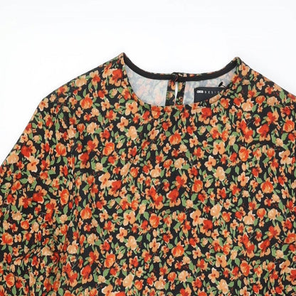 Close-up detail of ASOS women’s black floral polyester shift, size UK 8, round neck button