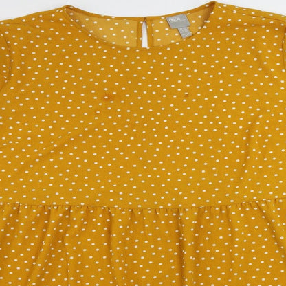 Close-up detail of ASOS women’s yellow polka dot polyester a-line, size UK 24, round neck button