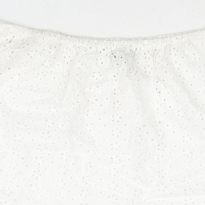 Brand and care label for ASOS women’s white cotton basic blouse, size UK 10, off the shoulder