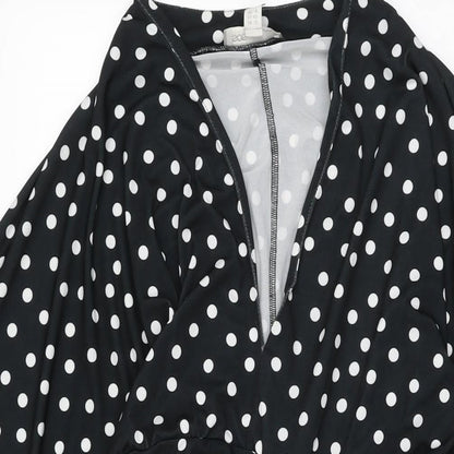 Close-up detail of ASOS women’s black polka dot polyester shift, size UK 12, v-neck pullover