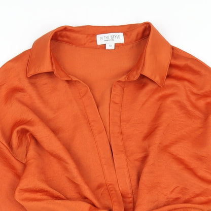 Close-up detail of In the Style women’s orange polyester mini, size UK 10, v-neck zip