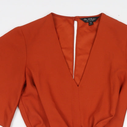 Close-up detail of Miss Selfridge women’s orange polyester a-line, size UK 4, v-neck button