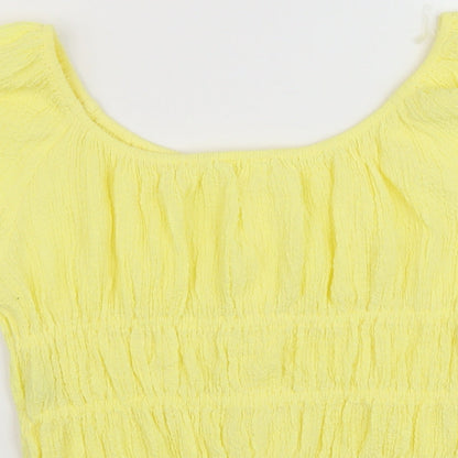 Brand and care label for Marks & Spencer girls’ yellow polyester basic blouse, size 13-14, years round neck button
