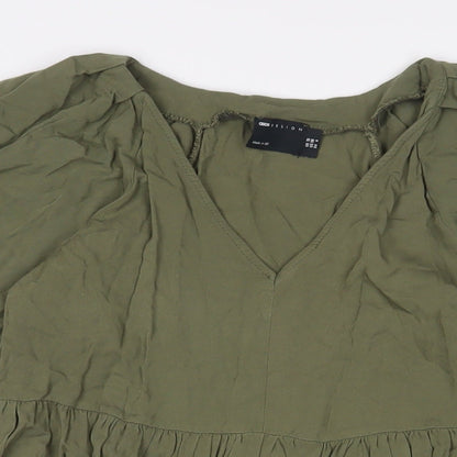Close-up detail of ASOS women’s green viscose a-line, size UK 10, v-neck pullover