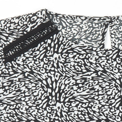 Close-up detail of Dunnes women’s ivory geometric polyester tunic blouse, size XS, round neck