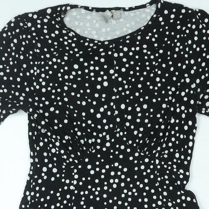 Close-up detail of ASOS women’s black polka dot viscose a-line, size UK 10, round neck pullover