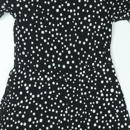 Brand and care label for ASOS women’s black polka dot viscose a-line, size UK 10, round neck pullover