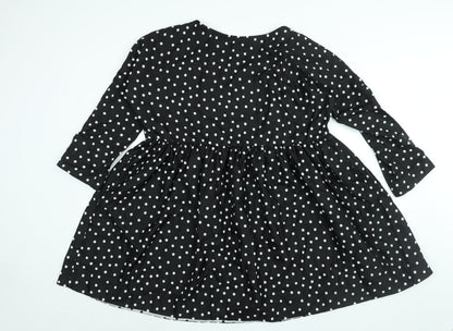Back view of ASOS women’s black polka dot polyester a-line, size UK 12, round neck pullover