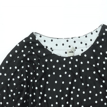 Close-up detail of ASOS women’s black polka dot polyester a-line, size UK 12, round neck pullover