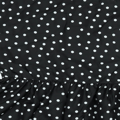 Brand and care label for ASOS women’s black polka dot polyester a-line, size UK 12, round neck pullover