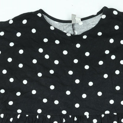 Close-up detail of ASOS women’s black polka dot cotton shift, size UK 14, round neck pullover - smocked