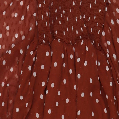 Close-up detail of ASOS women’s brown polka dot polyester a-line, size UK 6, v-neck pullover