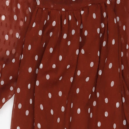 Brand and care label for ASOS women’s brown polka dot polyester a-line, size UK 6, v-neck pullover