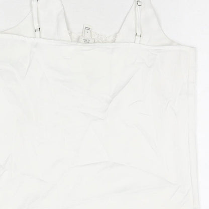 Brand and care label for Miss Selfridge women’s white polyester basic tank, size UK 6, v-neck