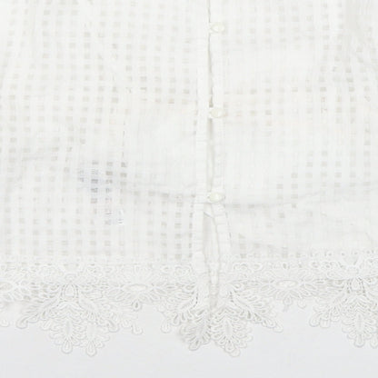 Brand and care label for Miss Selfridge women’s white check polyester basic blouse, size UK 6, round neck