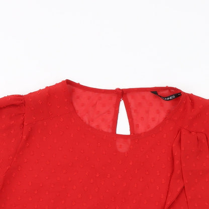 Close-up detail of Dunnes women’s red polyester basic blouse, size L, round neck