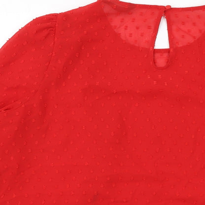 Brand and care label for Dunnes women’s red polyester basic blouse, size L, round neck
