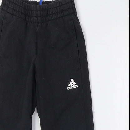 Close-up detail of Adidas boys’ black jogger trousers with side stripe