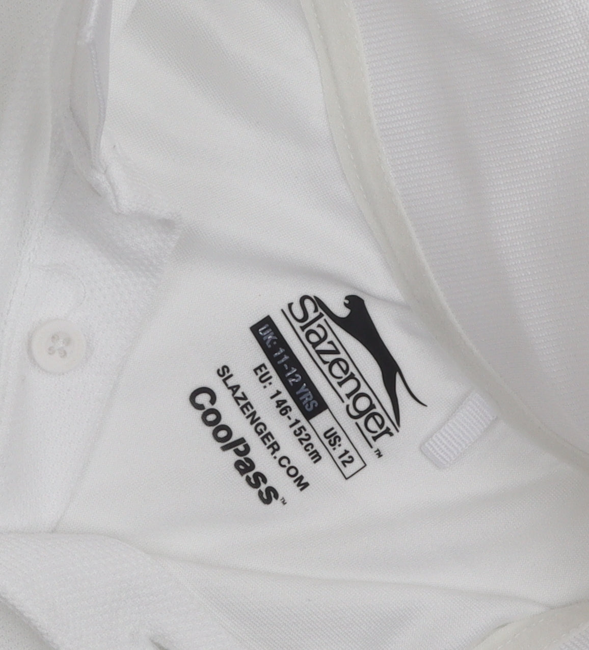 Close-up detail of Slazenger boys’ white polo shirt, age 11-12, logo accent