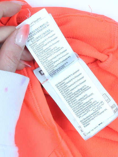 Brand and care label for Decathlon girls’ orange 1/4 zip sweatshirt, 5-6 years, lightweight