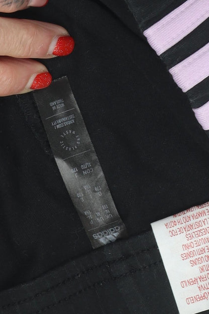 Close-up detail of Adidas girls’ black track pants l regular fit activewear