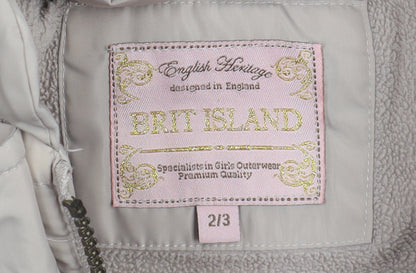 Close-up detail of Brit Island girls’ beige puffer jacket, size 2-3, with fur trim