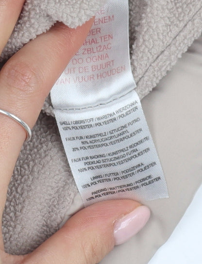 Brand and care label for Brit Island girls’ beige puffer jacket, size 2-3, with fur trim