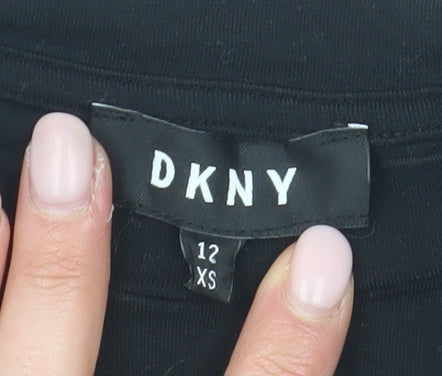 Close-up detail of DKNY girls’ black xs graphic print t-shirt logo