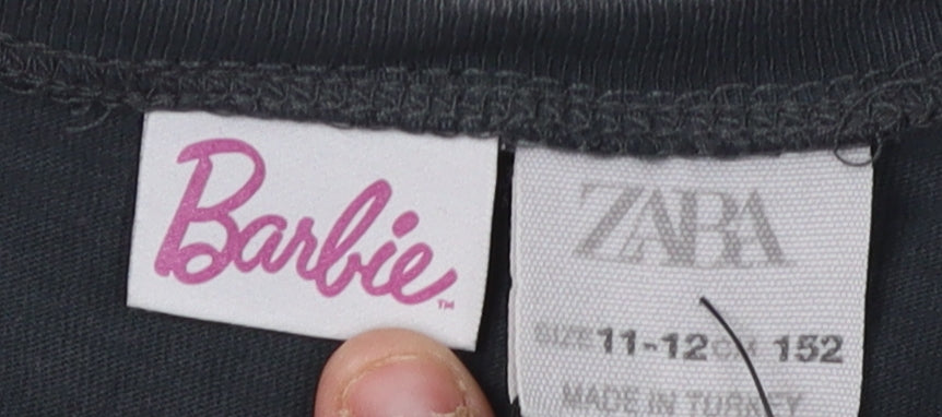Close-up detail of Barbie girls’ black cropped t-shirt 11-12 years graphic logo