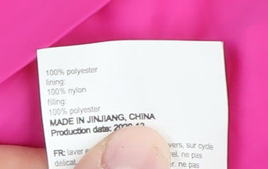 Brand and care label for Mountain Warehouse girls’ beige puffer jacket 13 years