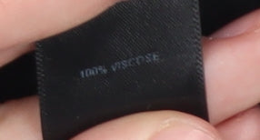 Close-up detail of ASOS Women's Black Sleeveless Button-Up Top, size 10