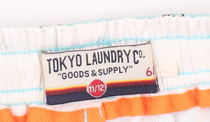 Brand and care label for Tokyo Laundry boys’ blue swim shorts 11 years, beach pattern